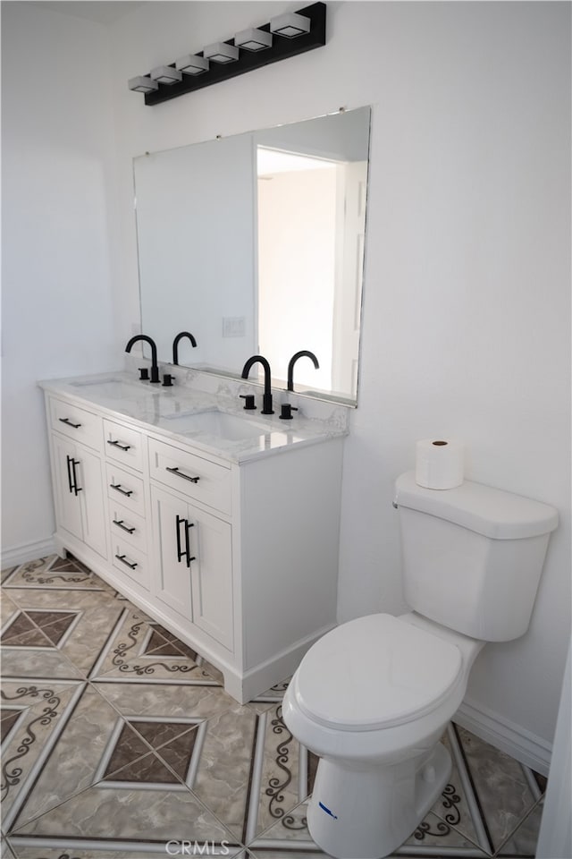 bathroom with tile patterned floors, vanity, and toilet