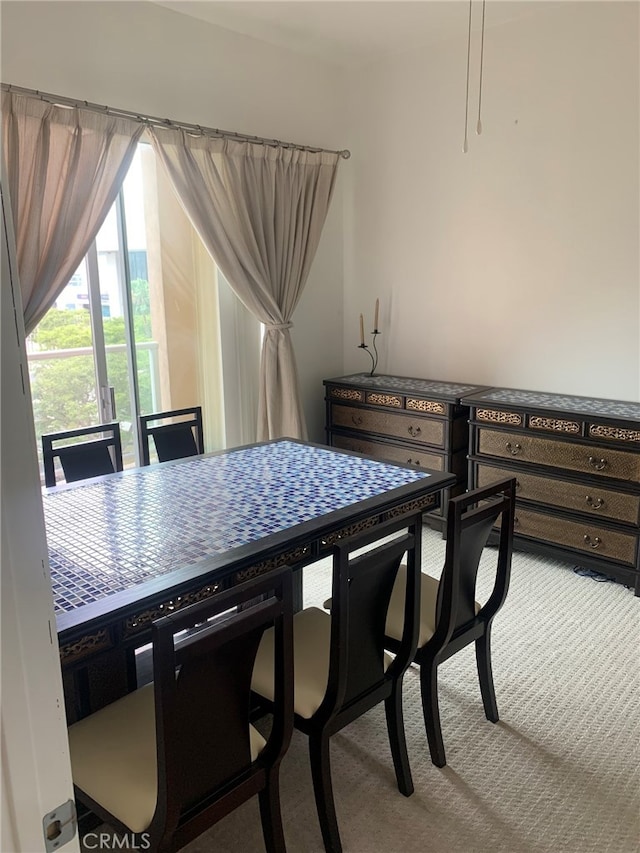 dining room featuring light carpet