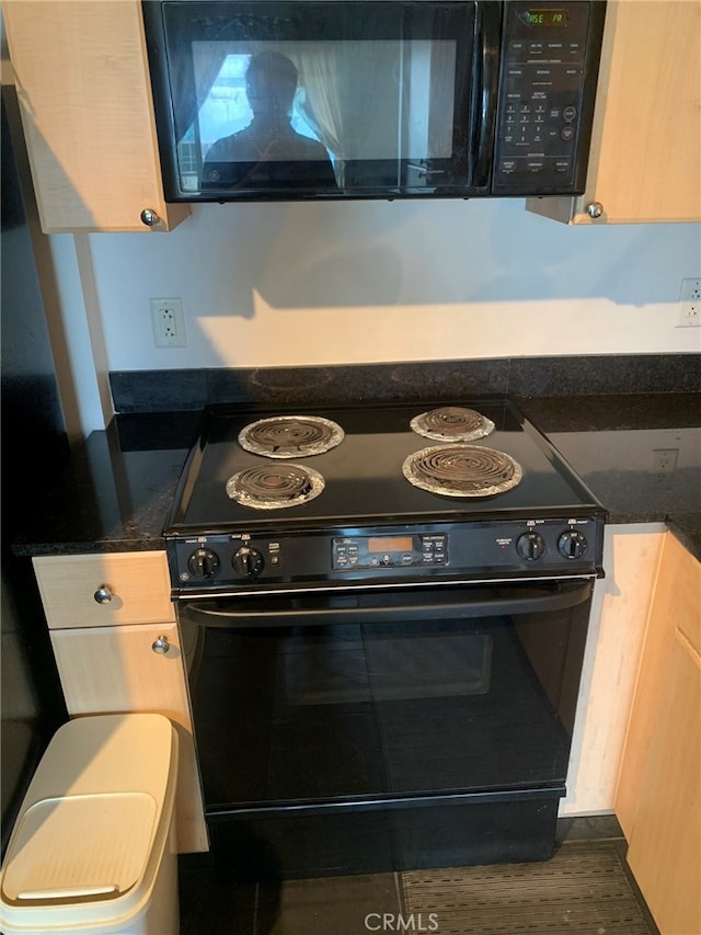 interior space with light brown cabinets, dark hardwood / wood-style flooring, and black appliances