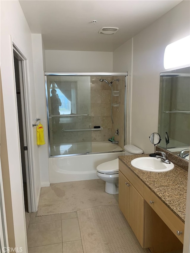 full bathroom featuring shower / bath combination with glass door, vanity, toilet, and tile patterned floors