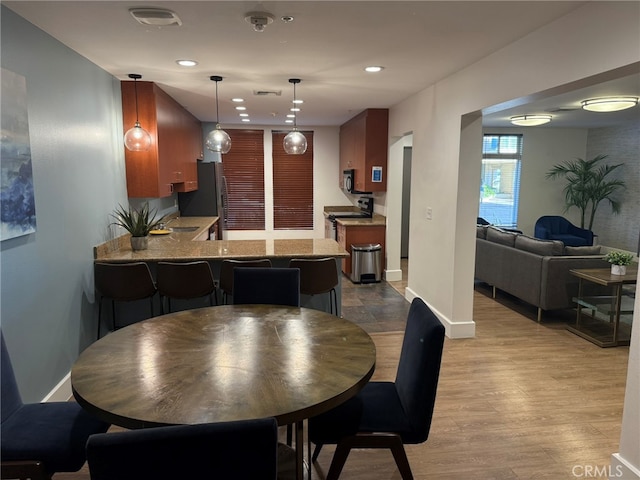 dining space featuring light hardwood / wood-style floors and sink