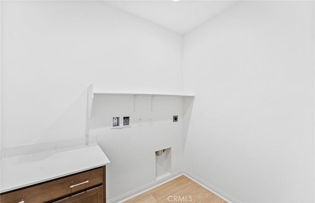 washroom with light wood-style flooring, hookup for an electric dryer, laundry area, washer hookup, and baseboards