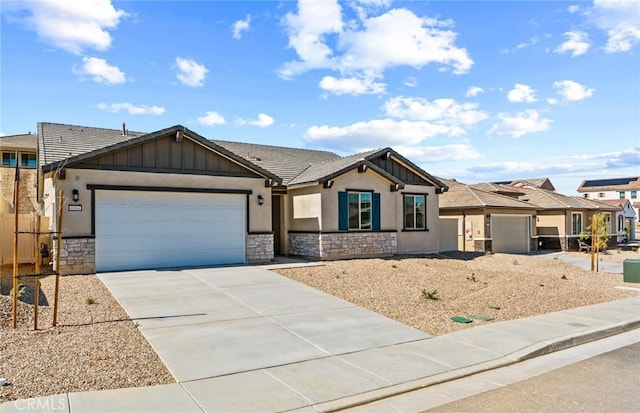 ranch-style home featuring an attached garage, stone siding, driveway, and board and batten siding