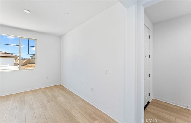 unfurnished room featuring light wood-style floors and baseboards