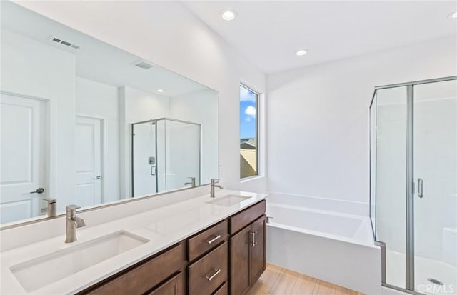 full bath with a stall shower, visible vents, a sink, and a bath