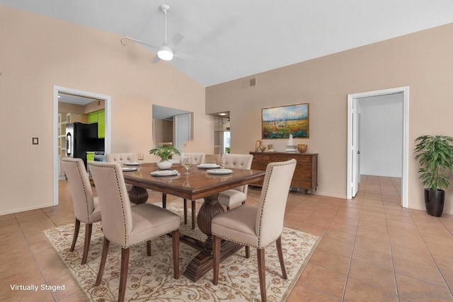 dining area with ceiling fan, light tile patterned floors, and high vaulted ceiling