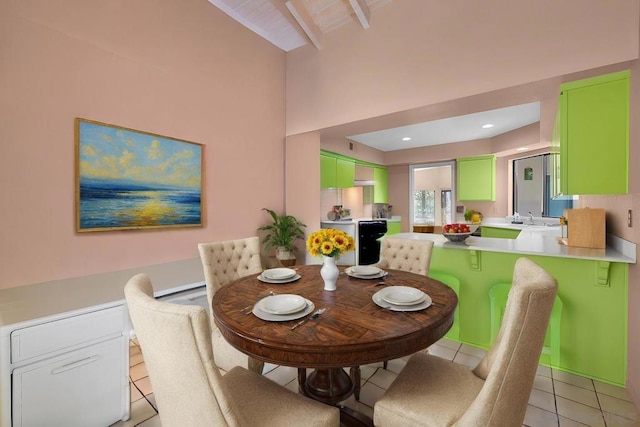 dining space featuring light tile patterned flooring, lofted ceiling with beams, and sink