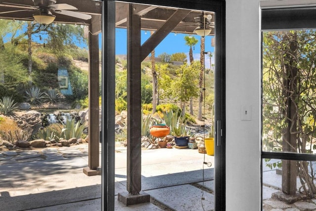 doorway to outside featuring ceiling fan