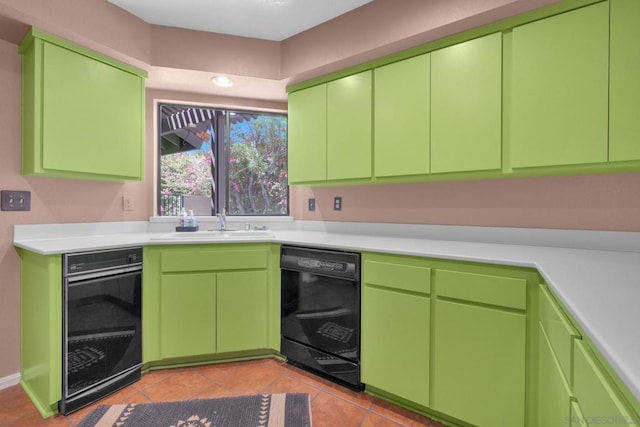 kitchen with green cabinets, light tile patterned floors, dishwasher, and sink