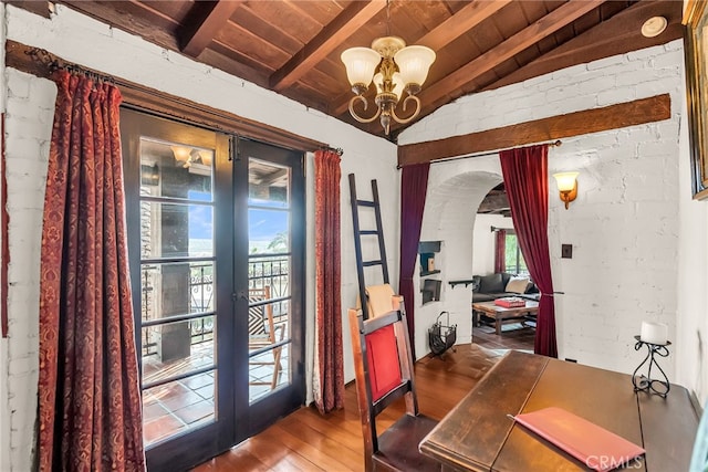 entryway featuring an inviting chandelier, wooden ceiling, brick wall, wood-type flooring, and lofted ceiling with beams