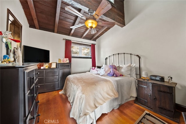 bedroom with ceiling fan, wooden ceiling, dark hardwood / wood-style floors, and lofted ceiling with beams