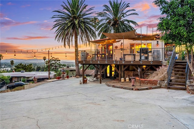 patio terrace at dusk with a deck with mountain view