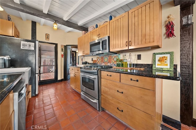 kitchen featuring light brown cabinetry, appliances with stainless steel finishes, beamed ceiling, and dark tile patterned flooring