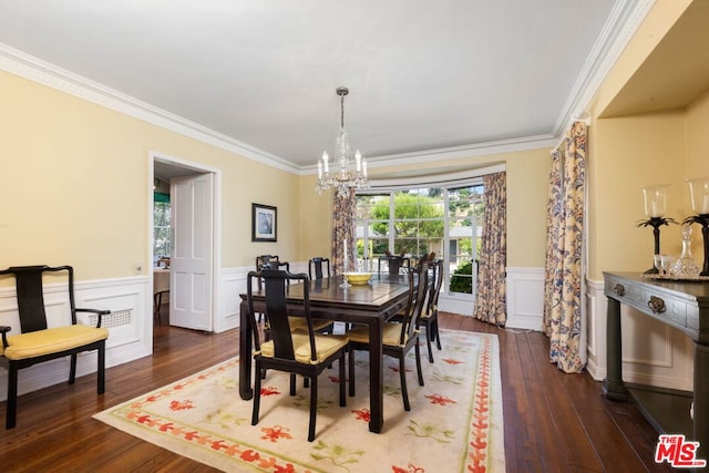 dining area featuring dark hardwood / wood-style floors, ornamental molding, and a notable chandelier