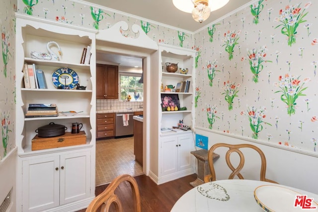 dining area with dark hardwood / wood-style floors and ornamental molding