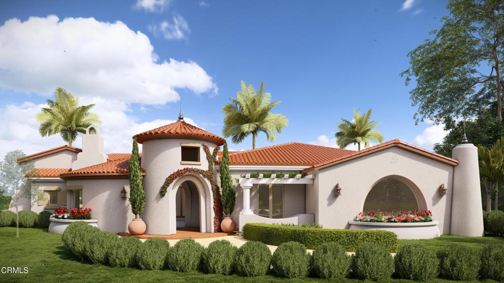 rear view of property with a yard, a chimney, a tile roof, and stucco siding