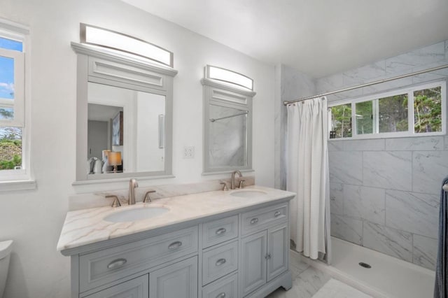 bathroom featuring curtained shower, toilet, and vanity