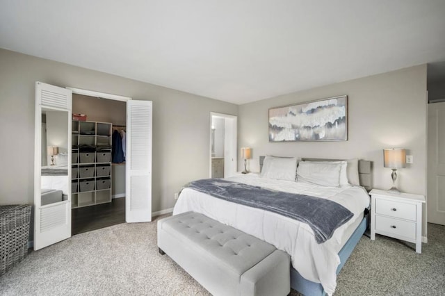 bedroom featuring a walk in closet, a closet, and carpet flooring