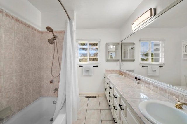 bathroom with shower / bath combo, a healthy amount of sunlight, tile patterned floors, and vanity