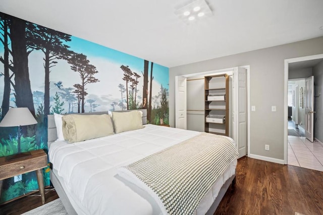 bedroom with a closet and hardwood / wood-style flooring