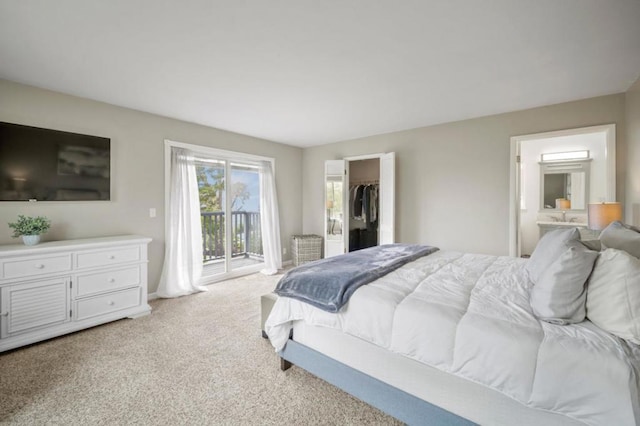 carpeted bedroom with access to exterior, a closet, and a walk in closet