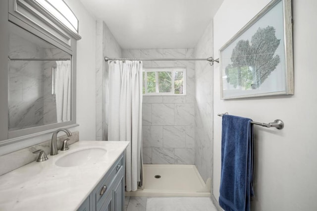 bathroom with walk in shower and vanity