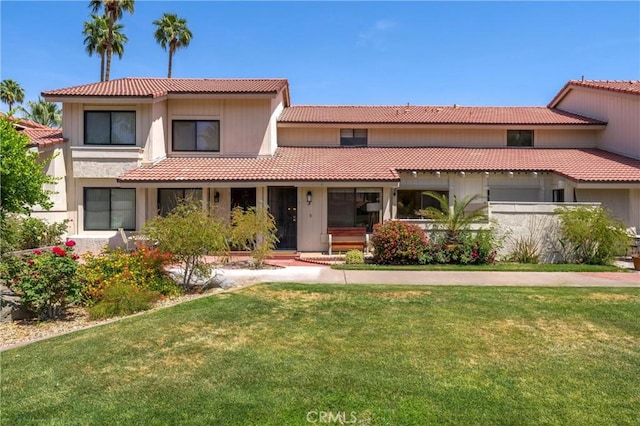 mediterranean / spanish house with a front lawn