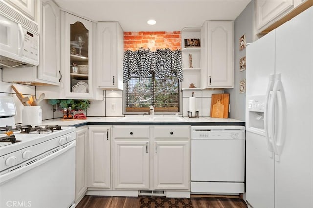 kitchen with white appliances, dark hardwood / wood-style floors, white cabinetry, and sink