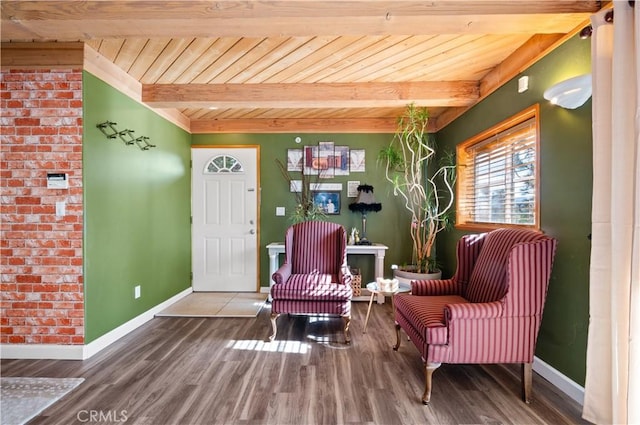 sitting room with beamed ceiling, wood ceiling, and hardwood / wood-style flooring