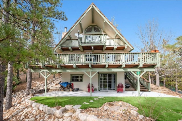 back of property featuring a lawn and a patio area