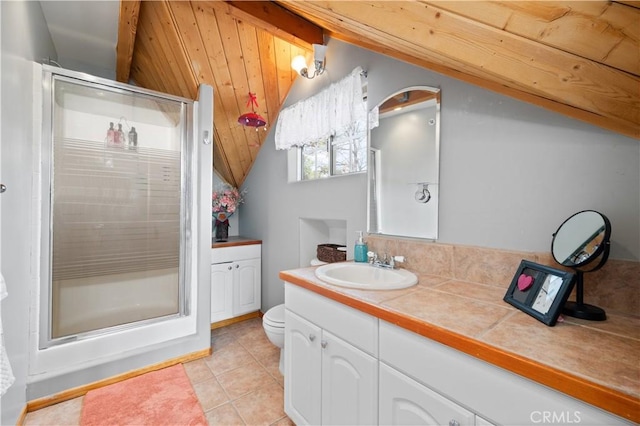 bathroom featuring vanity, a shower with door, lofted ceiling with beams, tile patterned flooring, and toilet