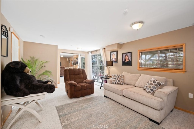 carpeted living room featuring plenty of natural light