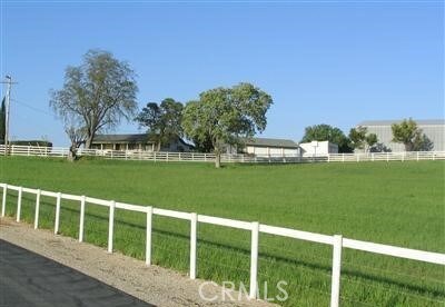 view of yard with a rural view and fence