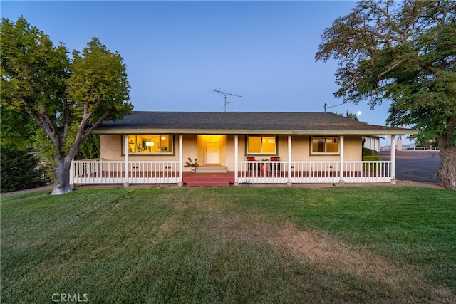 ranch-style home with a front lawn and a porch