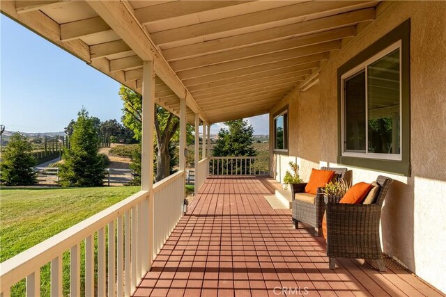 wooden terrace with a yard