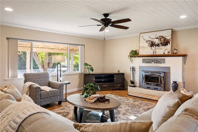 living room featuring ornamental molding, a brick fireplace, ceiling fan, and hardwood / wood-style flooring