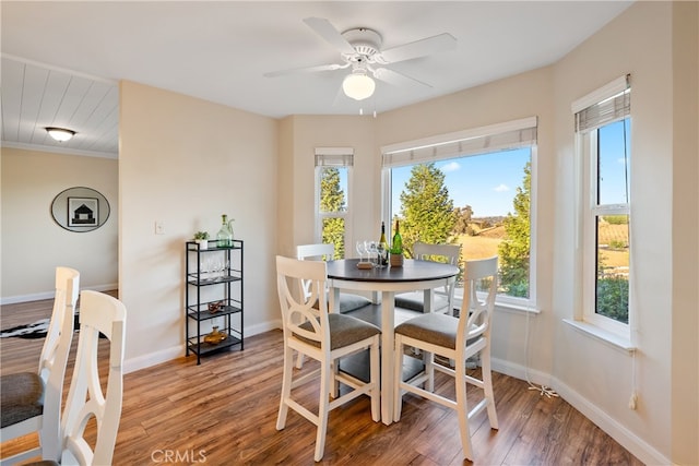 dining space featuring ornamental molding, ceiling fan, and hardwood / wood-style flooring