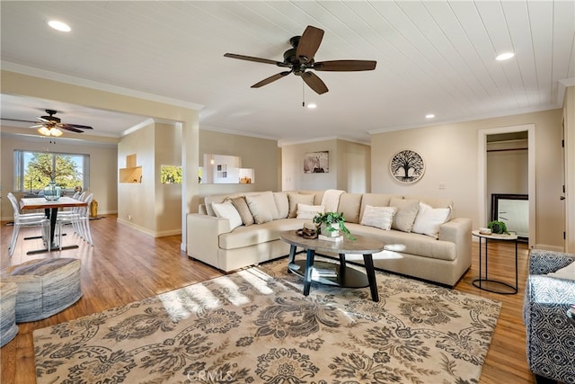 living room with ceiling fan, light hardwood / wood-style flooring, and crown molding