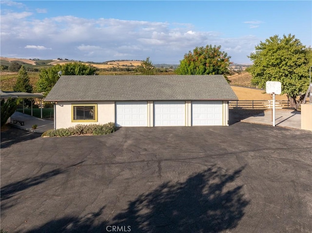 detached garage featuring fence