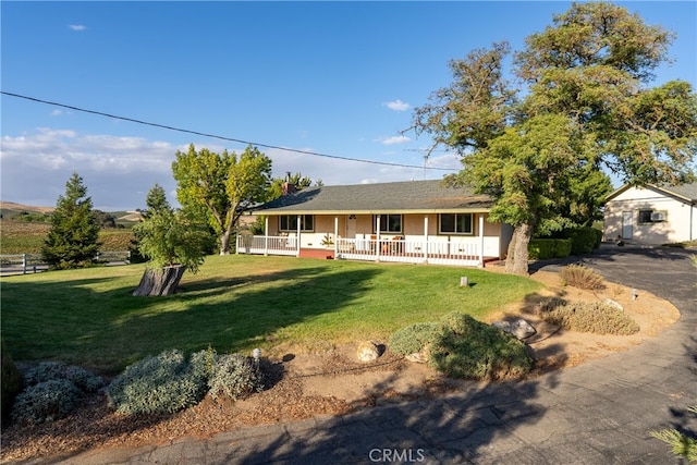 view of front of house with a porch and a front yard