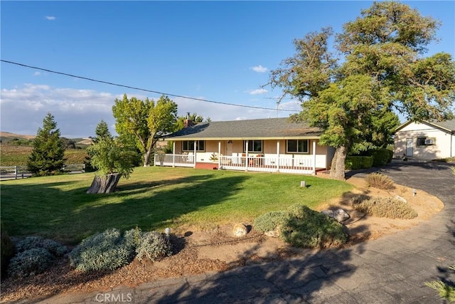 view of front of house with a porch and a front lawn