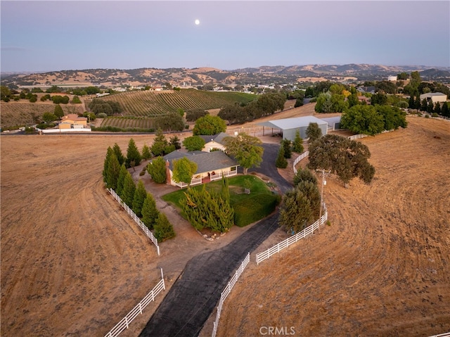 birds eye view of property with a mountain view and a rural view