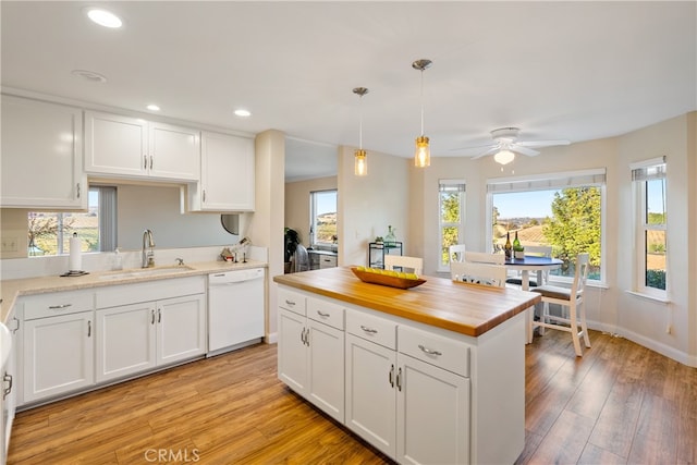 kitchen with ceiling fan, dishwasher, plenty of natural light, and light hardwood / wood-style floors