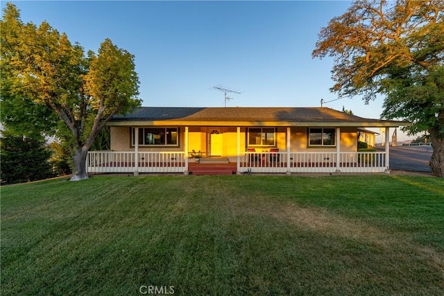 ranch-style house with a porch and a front yard