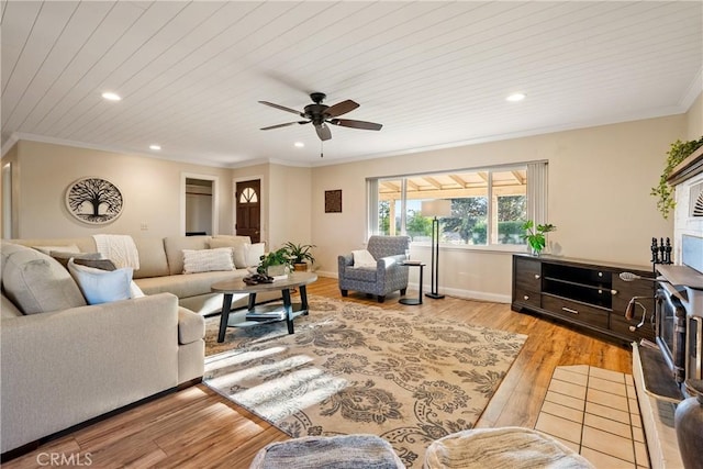 living area with crown molding, ceiling fan, recessed lighting, and light wood-style flooring