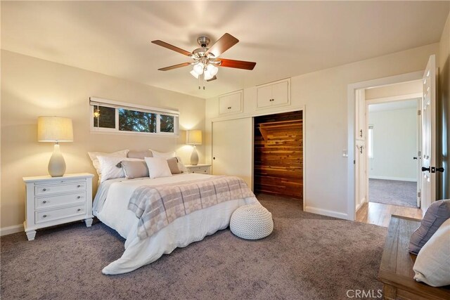 bedroom featuring a closet, carpet flooring, ceiling fan, and baseboards