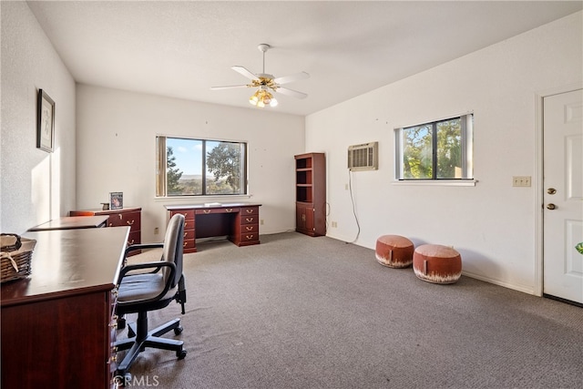 office area with light carpet, a wall unit AC, and ceiling fan