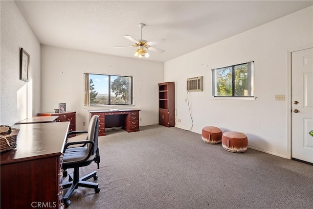 carpeted home office featuring ceiling fan, a wall unit AC, and a healthy amount of sunlight
