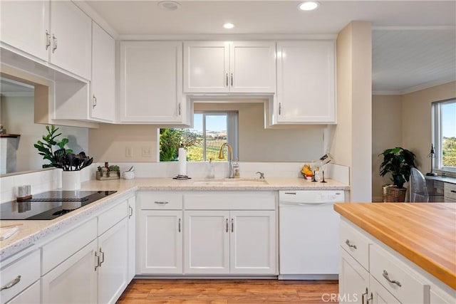 kitchen featuring black electric stovetop, recessed lighting, white cabinetry, white dishwasher, and a sink