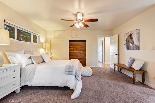 carpeted bedroom with a closet, baseboards, and a ceiling fan
